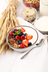 Tasty homemade granola served on table. Healthy breakfast with a bowl of oatmeal with banana, blueberries, strawberries and healthy food for Breakfast