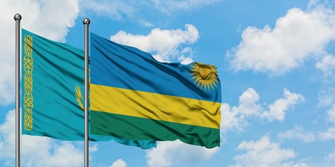 Kazakhstan and Rwanda flag waving in the wind against white cloudy blue sky together. Diplomacy concept, international relations.