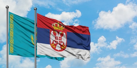 Kazakhstan and Serbia flag waving in the wind against white cloudy blue sky together. Diplomacy concept, international relations.