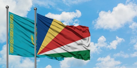 Kazakhstan and Seychelles flag waving in the wind against white cloudy blue sky together. Diplomacy concept, international relations.