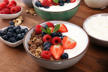 Tasty homemade granola served on table. Healthy breakfast with a bowl of oatmeal with banana, blueberries, strawberries and healthy food for Breakfast
