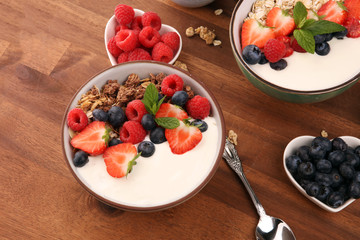 Tasty homemade granola served on table. Healthy breakfast with a bowl of oatmeal with banana, blueberries, strawberries and healthy food for Breakfast