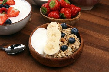 Tasty homemade granola served on table. Healthy breakfast with a bowl of oatmeal with banana, blueberries, strawberries and healthy food for Breakfast