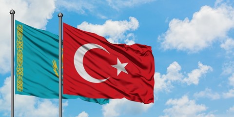 Kazakhstan and Turkey flag waving in the wind against white cloudy blue sky together. Diplomacy...