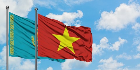 Kazakhstan and Vietnam flag waving in the wind against white cloudy blue sky together. Diplomacy concept, international relations.
