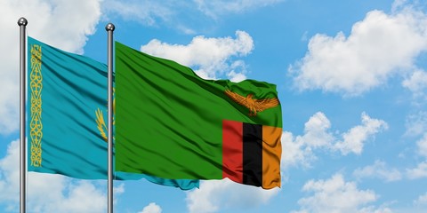 Kazakhstan and Zambia flag waving in the wind against white cloudy blue sky together. Diplomacy concept, international relations.
