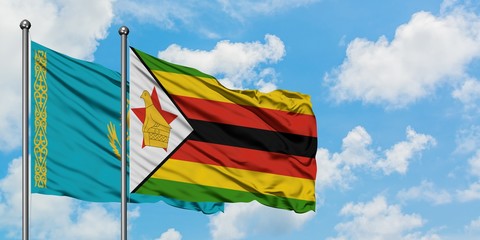 Kazakhstan and Zimbabwe flag waving in the wind against white cloudy blue sky together. Diplomacy concept, international relations.