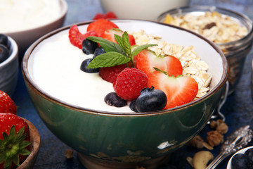Tasty homemade granola served on table. Healthy breakfast with a bowl of oatmeal with banana, blueberries, strawberries and healthy food for Breakfast