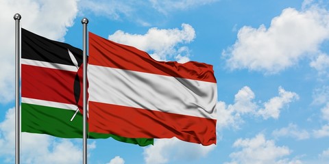Kenya and Austria flag waving in the wind against white cloudy blue sky together. Diplomacy concept, international relations.