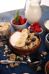 Tasty homemade granola served on table. Healthy breakfast with a bowl of oatmeal with banana, blueberries, strawberries and healthy food for Breakfast