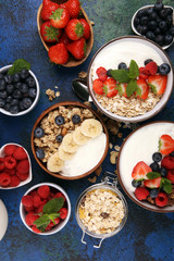 Tasty homemade granola served on table. Healthy breakfast with a bowl of oatmeal with banana, blueberries, strawberries and healthy food for Breakfast