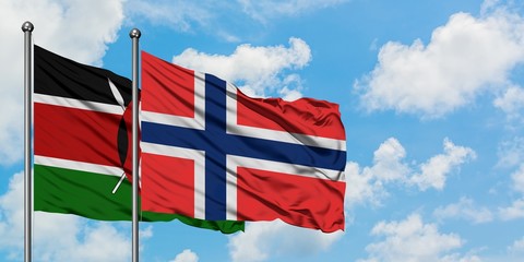 Kenya and Bouvet Islands flag waving in the wind against white cloudy blue sky together. Diplomacy...