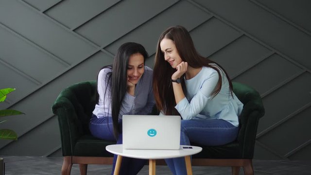Two girlfriends shop online, black friday concept