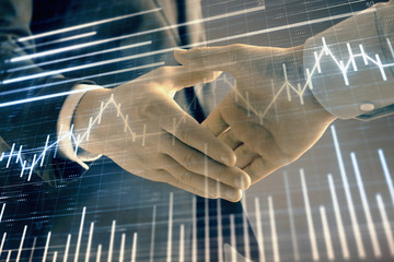 Multi exposure of forex graph on abstract background with two businessmen handshake. Concept of success on stock market