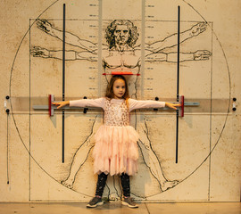 Little girl on the background of the Vitruvian man. The concept of body proportions