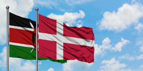 Kenya and Denmark flag waving in the wind against white cloudy blue sky together. Diplomacy concept, international relations.