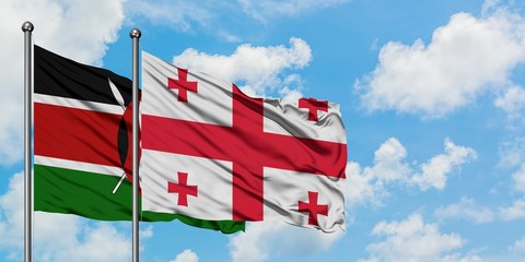 Kenya and Georgia flag waving in the wind against white cloudy blue sky together. Diplomacy...