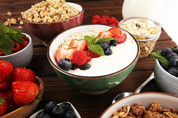 Tasty homemade granola served on table. Healthy breakfast with a bowl of oatmeal with banana, blueberries, strawberries and healthy food for Breakfast