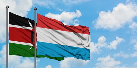 Kenya and Luxembourg flag waving in the wind against white cloudy blue sky together. Diplomacy...