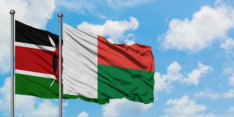 Kenya and Madagascar flag waving in the wind against white cloudy blue sky together. Diplomacy concept, international relations.