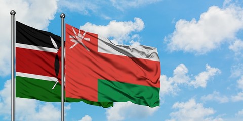 Kenya and Oman flag waving in the wind against white cloudy blue sky together. Diplomacy concept, international relations.