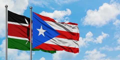 Kenya and Puerto Rico flag waving in the wind against white cloudy blue sky together. Diplomacy concept, international relations.