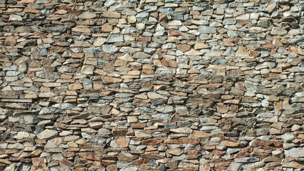 The texture of the walls of the old castle is made of natural stone