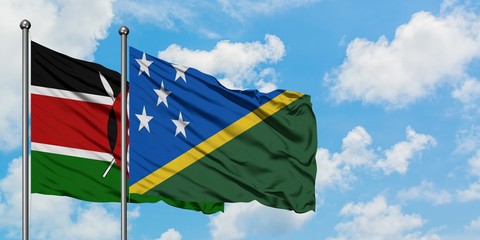 Kenya and Solomon Islands flag waving in the wind against white cloudy blue sky together. Diplomacy concept, international relations.