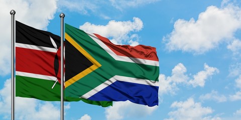 Kenya and South Africa flag waving in the wind against white cloudy blue sky together. Diplomacy...