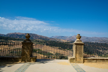 Scenic viewpoint to valley and mountains from Ronda, small ancient white town in Andalusia, Spain