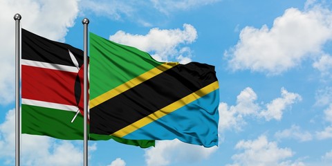 Kenya and Tanzania flag waving in the wind against white cloudy blue sky together. Diplomacy concept, international relations.