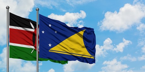 Kenya and Tokelau flag waving in the wind against white cloudy blue sky together. Diplomacy...
