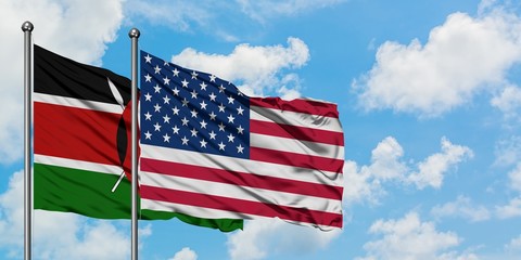 Kenya and United States flag waving in the wind against white cloudy blue sky together. Diplomacy concept, international relations.