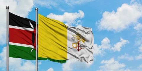 Kenya and Vatican City flag waving in the wind against white cloudy blue sky together. Diplomacy concept, international relations.