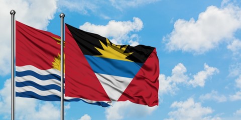 Kiribati and Antigua and Barbuda flag waving in the wind against white cloudy blue sky together. Diplomacy concept, international relations.