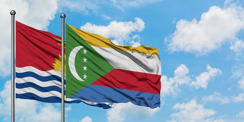 Kiribati and Comoros flag waving in the wind against white cloudy blue sky together. Diplomacy...