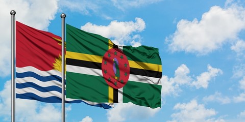 Kiribati and Dominica flag waving in the wind against white cloudy blue sky together. Diplomacy...
