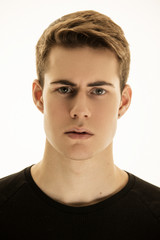 Fototapeta premium Muscle strong beautiful stripped male model in denim jeans and black t-shirt with belt on white isolated font background