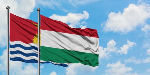 Kiribati and Hungary flag waving in the wind against white cloudy blue sky together. Diplomacy concept, international relations.