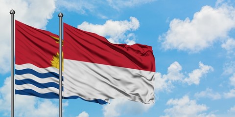Kiribati and Indonesia flag waving in the wind against white cloudy blue sky together. Diplomacy concept, international relations.