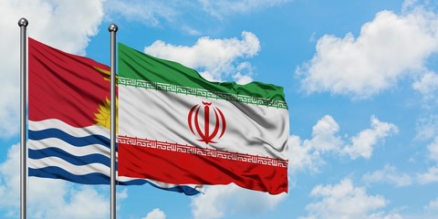 Kiribati and Iran flag waving in the wind against white cloudy blue sky together. Diplomacy concept, international relations.