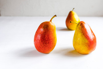 Trendy ugly organic fruits -three yellow pears on the table with copy space for text.  Buying...