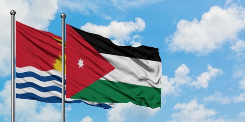 Kiribati and Jordan flag waving in the wind against white cloudy blue sky together. Diplomacy concept, international relations.