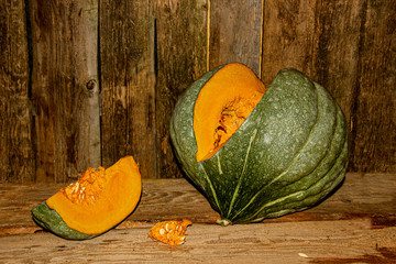 One big green fluted pumpkin on a dark background . It is a product for vegan and Keto diets. A storehouse of vitamins. Healthy food concept. © helen111