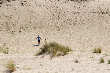 Parnidis dune in Nida. The Curonian Spit. Sand and Grass. People Walking On the Sand Dunes Images....