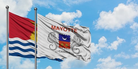 Kiribati and Mayotte flag waving in the wind against white cloudy blue sky together. Diplomacy concept, international relations.