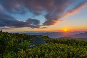 Beautiful summer in the Carpathian Mountains with tourists in tents with beautiful views ..