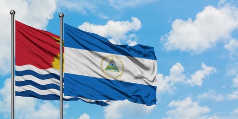 Kiribati and Nicaragua flag waving in the wind against white cloudy blue sky together. Diplomacy concept, international relations.