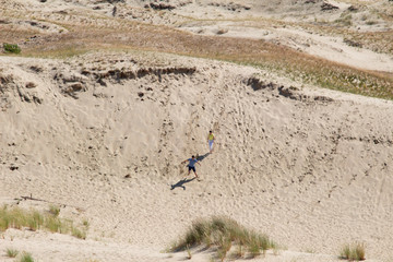 Parnidis dune in Nida. The Curonian Spit. Sand and Grass. People Walking On the Sand Dunes Images....