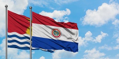 Kiribati and Paraguay flag waving in the wind against white cloudy blue sky together. Diplomacy concept, international relations.